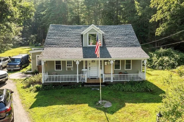 a view of a patio with dining table and chairs with wooden floor