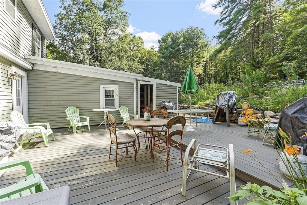 610 South Main Street Orange, MA 01364 - Photo 33 of 38 a view of a patio with dining table and chairs with wooden floor