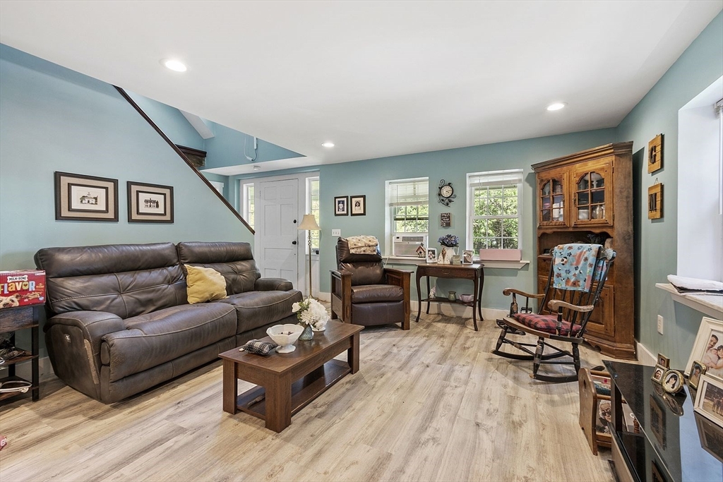 610 South Main Street Orange, MA 01364 - Photo 37 of 38 a living room with furniture and a flat screen tv with wooden floor