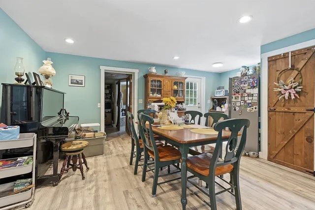 a dining room with furniture and wooden floor