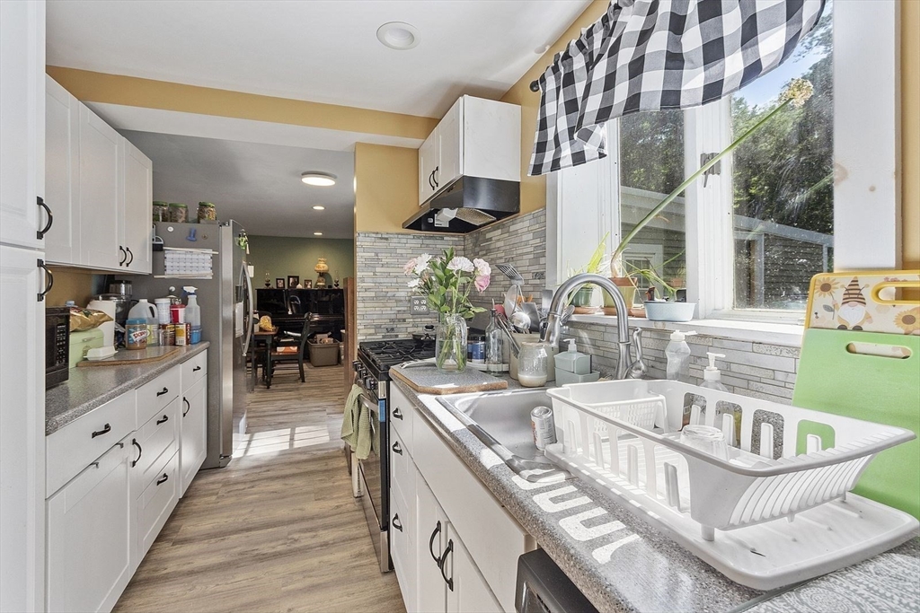 610 South Main Street Orange, MA 01364 - Photo 8 of 38 a kitchen with stainless steel appliances granite countertop a sink and a stove