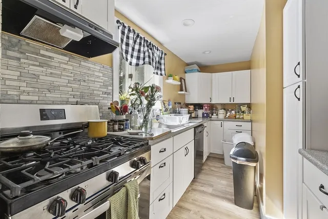 a kitchen with stainless steel appliances granite countertop a stove and a refrigerator