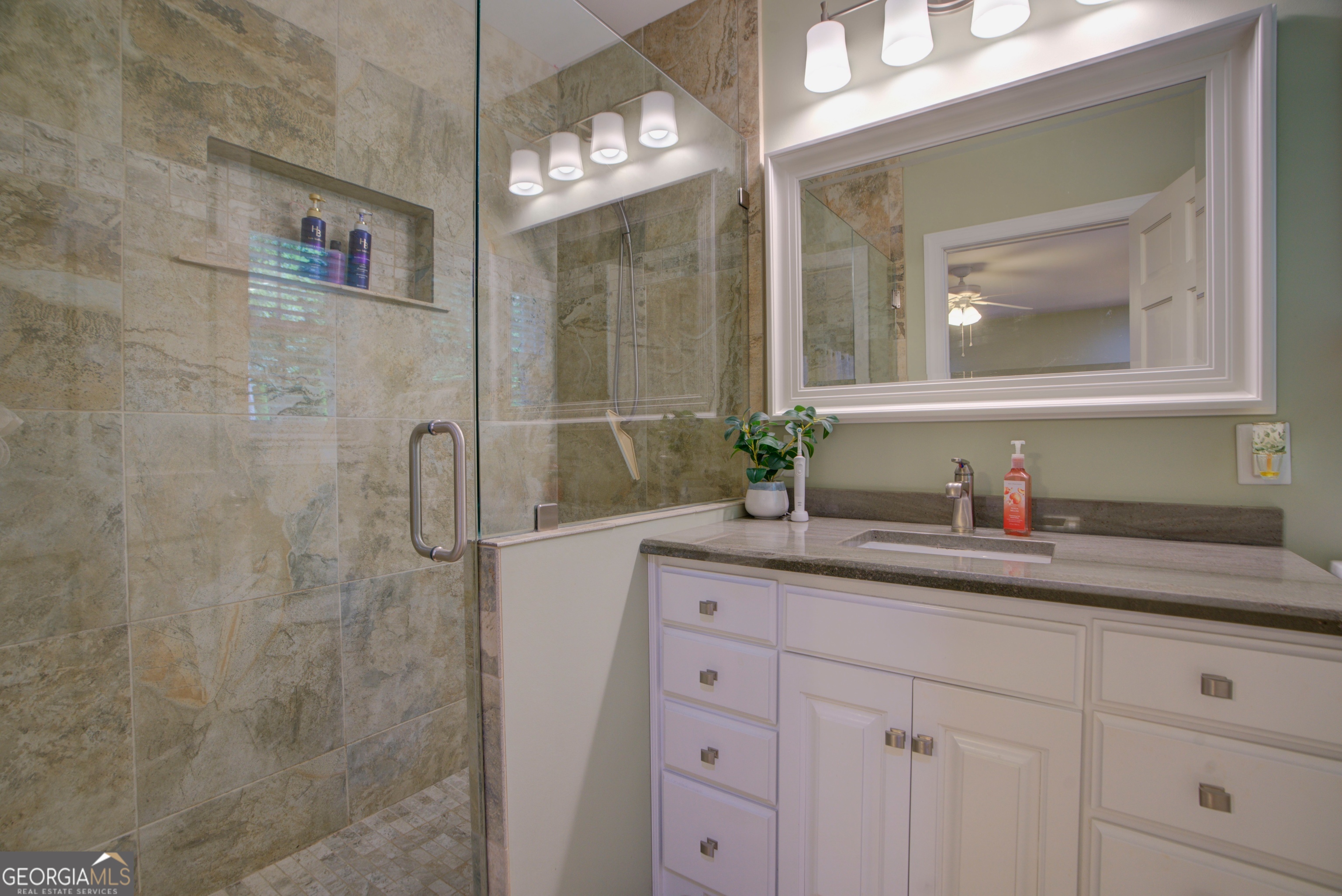 204 Green View Road Southwest Rome, GA 30165 - Photo 42 of 62 a bathroom with a granite countertop sink a mirror and a shower