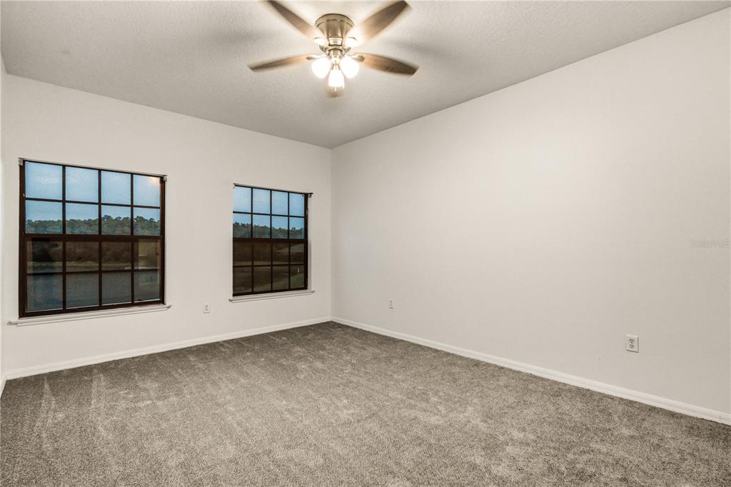 19214 Briercrest Trail Orlando, FL 32833 - Photo 12 of 47 an empty room with windows and fan