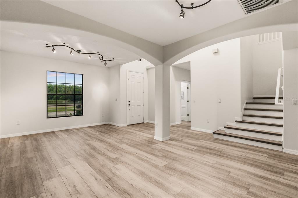 19214 Briercrest Trail Orlando, FL 32833 - Photo 2 of 47 a view of an empty room with wooden floor and windows