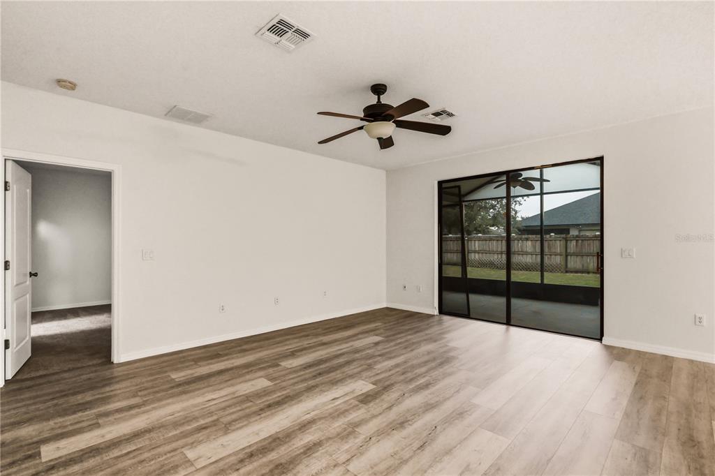 19214 Briercrest Trail Orlando, FL 32833 - Photo 25 of 47 a view of empty room with wooden floor and fan