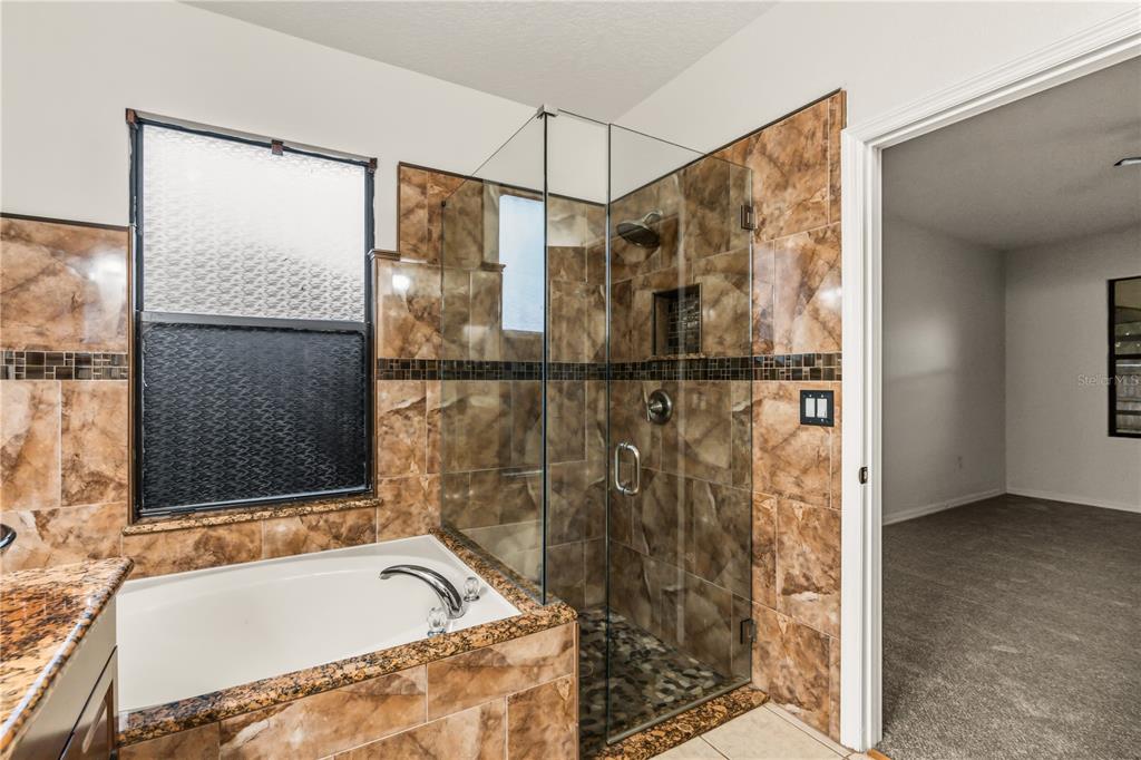 19214 Briercrest Trail Orlando, FL 32833 - Photo 26 of 47 a bathroom with a tub and a shower