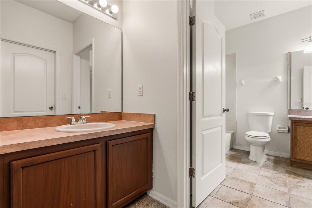 19214 Briercrest Trail Orlando, FL 32833 - Photo 28 of 47 a bathroom with a sink a toilet and a mirror