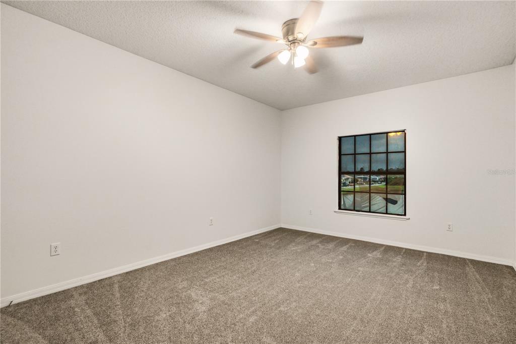 19214 Briercrest Trail Orlando, FL 32833 - Photo 30 of 47 an empty room with a window and a ceiling fan