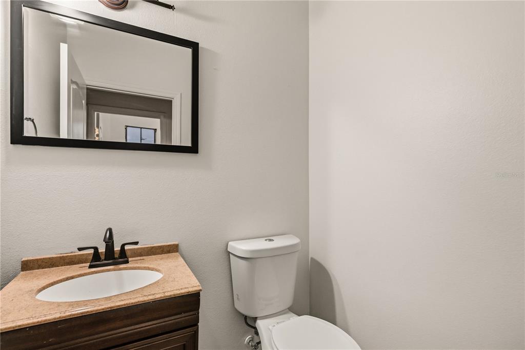 19214 Briercrest Trail Orlando, FL 32833 - Photo 4 of 47 a bathroom with a toilet a sink and mirror