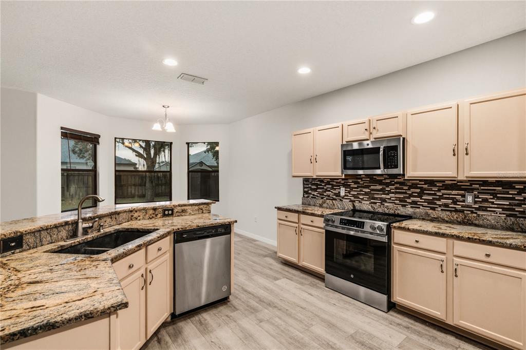19214 Briercrest Trail Orlando, FL 32833 - Photo 6 of 47 a kitchen with stainless steel appliances granite countertop a stove and a sink