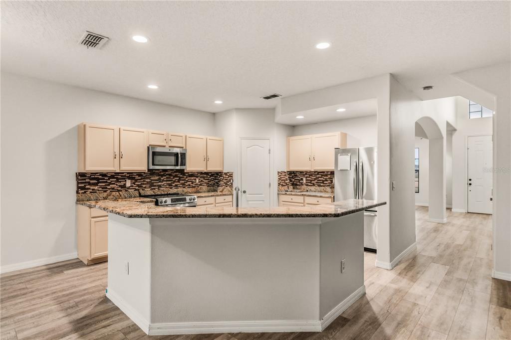 19214 Briercrest Trail Orlando, FL 32833 - Photo 7 of 47 a kitchen with stainless steel appliances granite countertop a sink and a refrigerator
