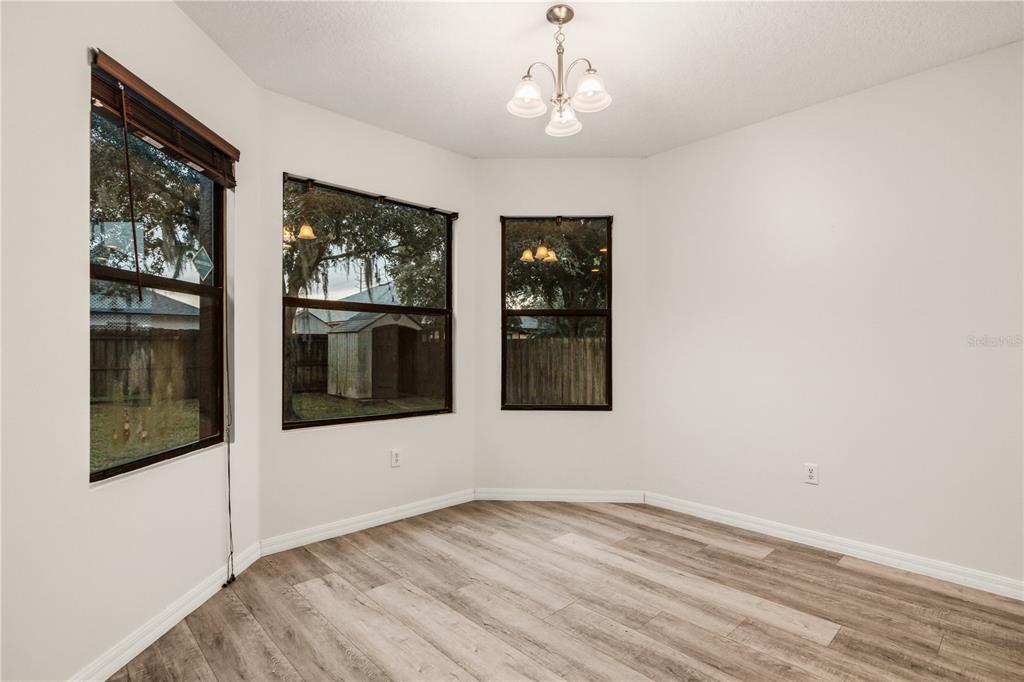 19214 Briercrest Trail Orlando, FL 32833 - Photo 9 of 47 a view of an empty room with a window and kitchen area