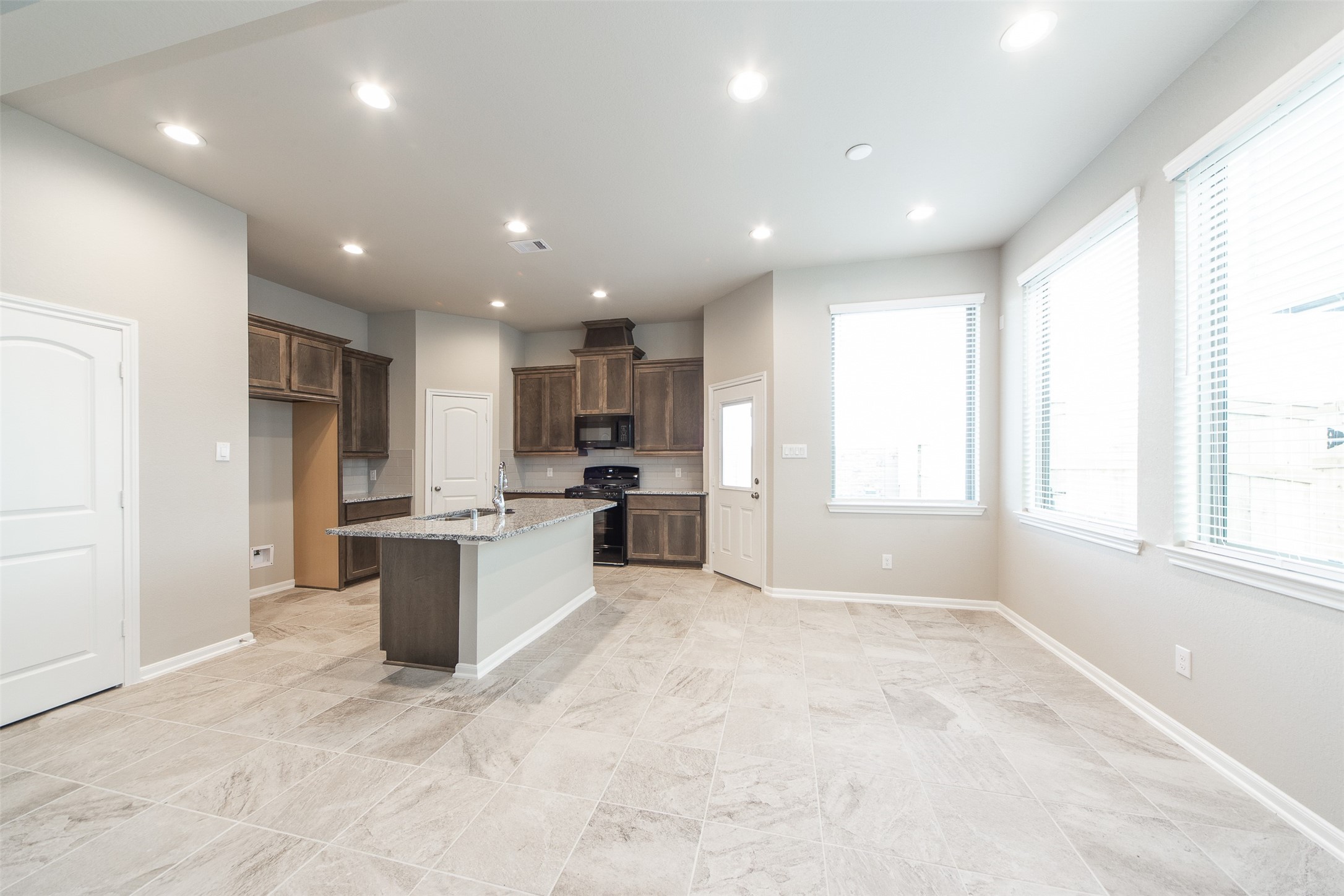 5131 Prairie Terrace Lane Fulshear, TX 77441 - Photo 6 of 21 a view of kitchen with stainless steel appliances granite countertop refrigerator stove microwave and cabinets