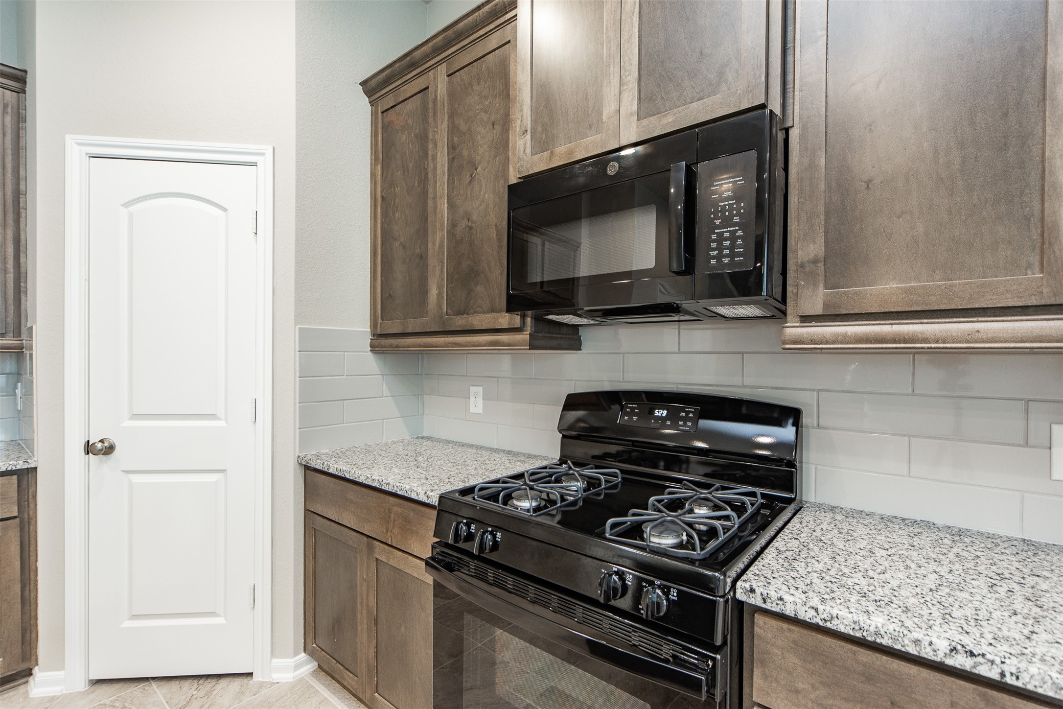 5131 Prairie Terrace Lane Fulshear, TX 77441 - Photo 8 of 21 a kitchen with a stove microwave and sink