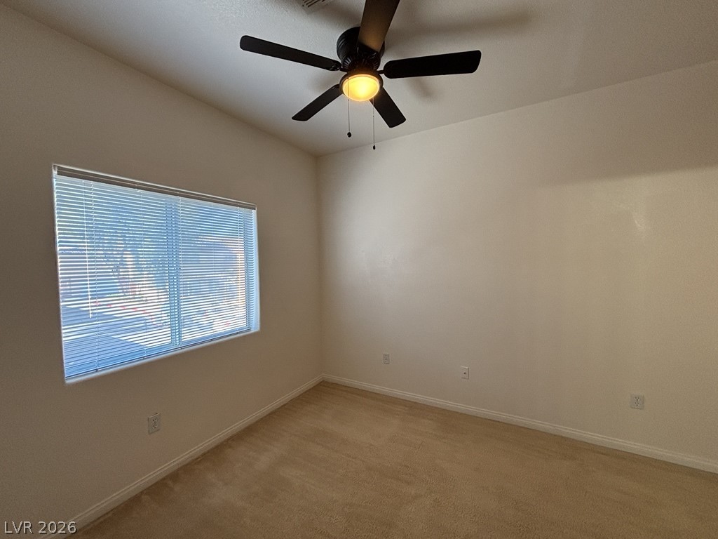 4915 East Russell Road, Unit 130 Las Vegas, NV 89120 - Photo 11 of 14 Empty room featuring light colored carpet and ceiling fan