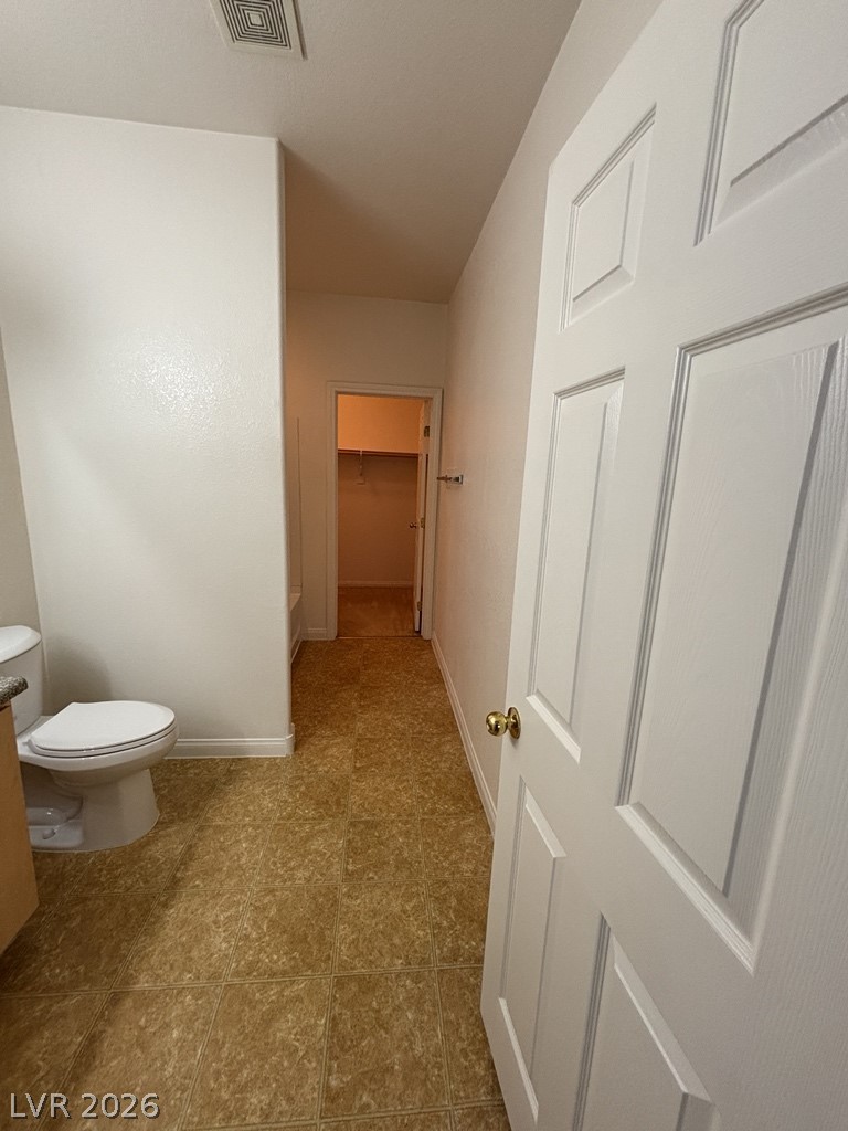 4915 East Russell Road, Unit 130 Las Vegas, NV 89120 - Photo 12 of 14 Bathroom featuring a walk in closet and toilet
