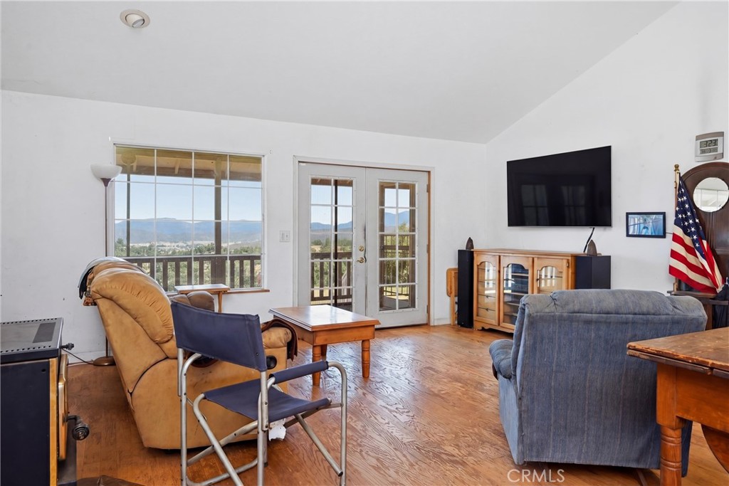 16965 Spruce Grove Road Hidden Valley Lake, CA 95467 - Photo 8 of 34 a living room with furniture a flat screen tv and a floor to ceiling window