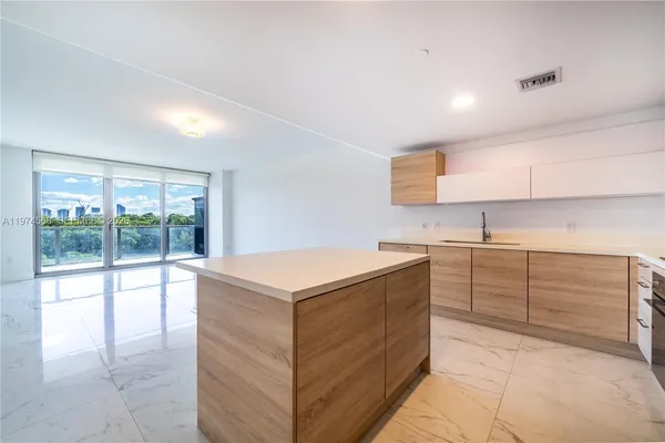 a kitchen with stainless steel appliances granite countertop a sink and dishwasher a stove with wooden floor