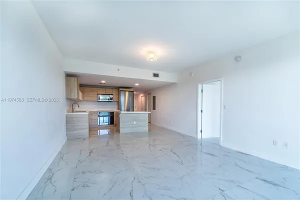 a view of a hallway with a kitchen