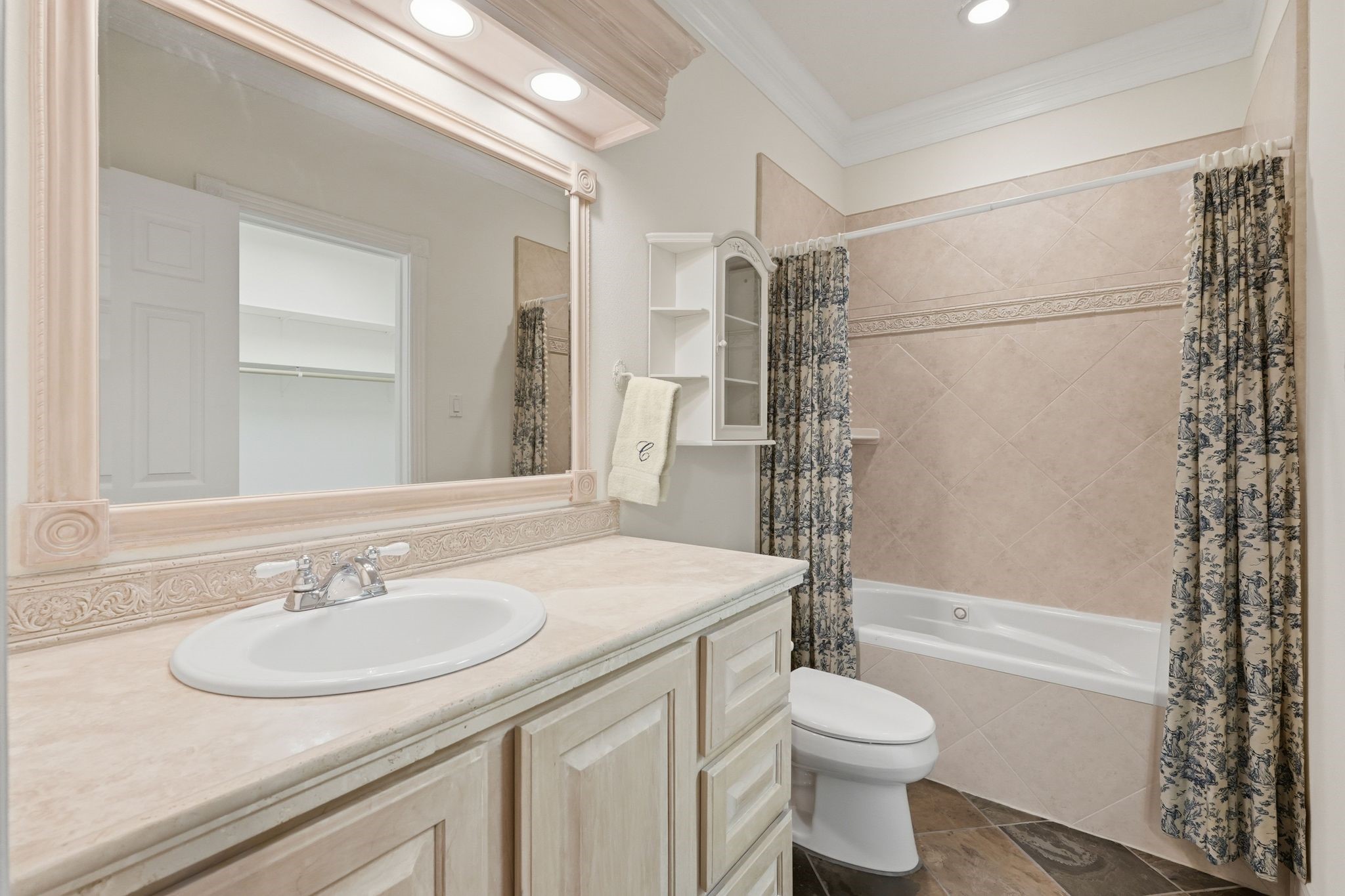 25014 Northampton Terrace Drive Spring, TX 77389 - Photo 27 of 41 The ensuite bathroom with tiled jacuzzi tub/shower combo and large trimmed out mirror with overhead lighting