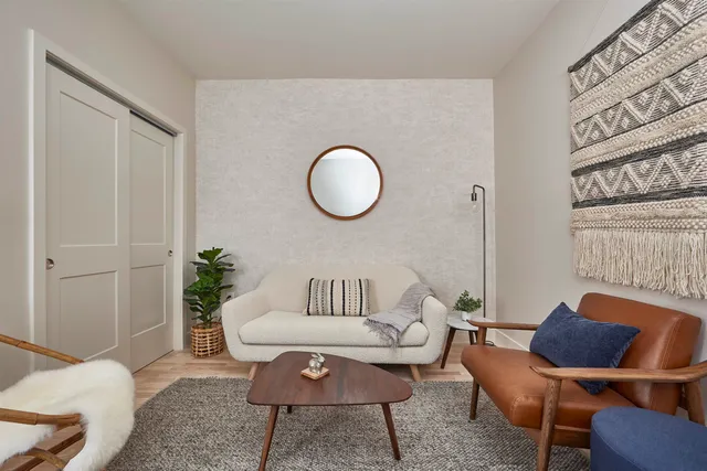 a living room with furniture and a chair