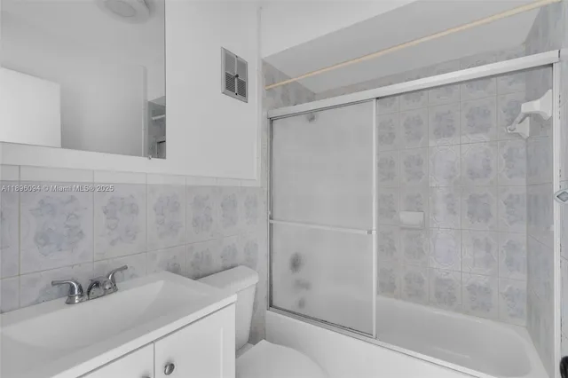 a bathroom with a shower and a toilet