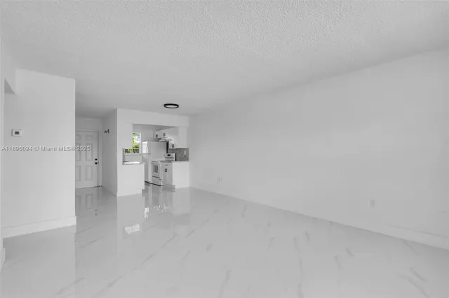 a view of an empty room with windows