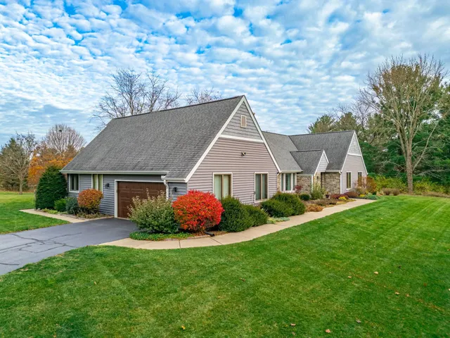 a aerial view of a house next to a yard