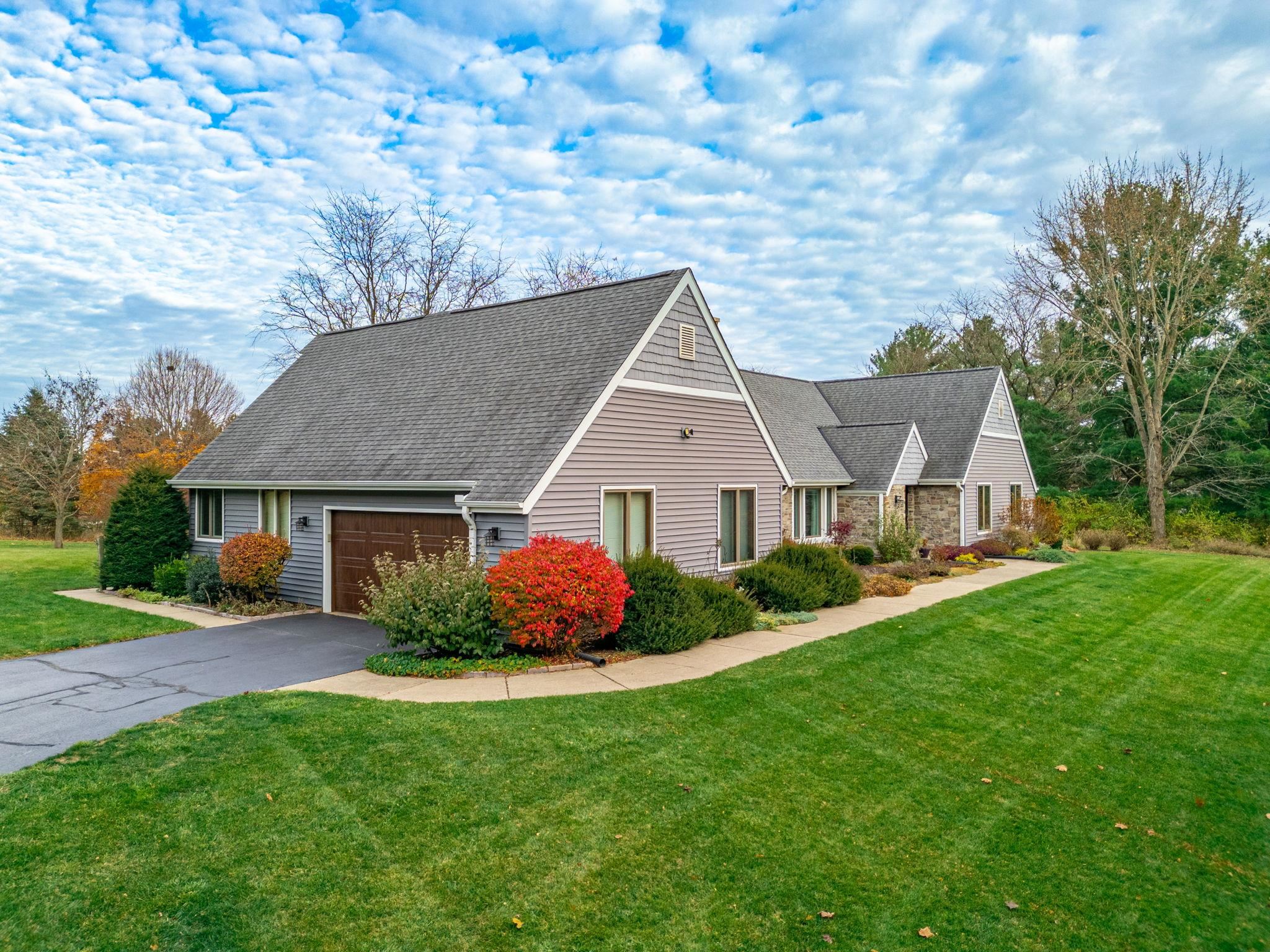 a aerial view of a house next to a yard