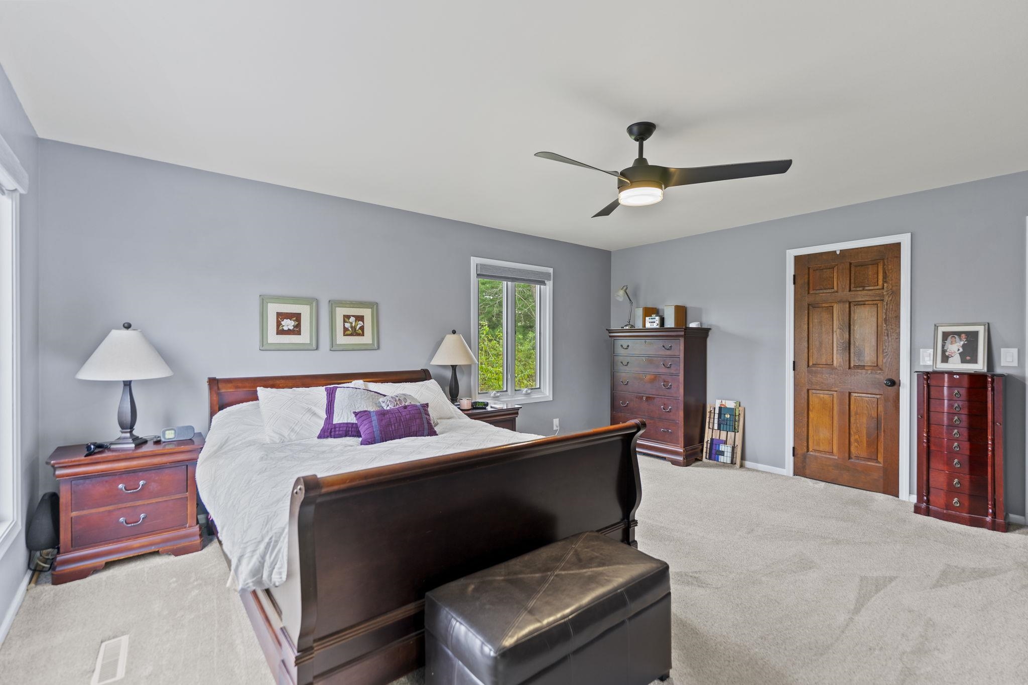 1628 Riverside Road Belvidere, IL 61008 - Photo 22 of 47 a bedroom with a bed and a chandelier