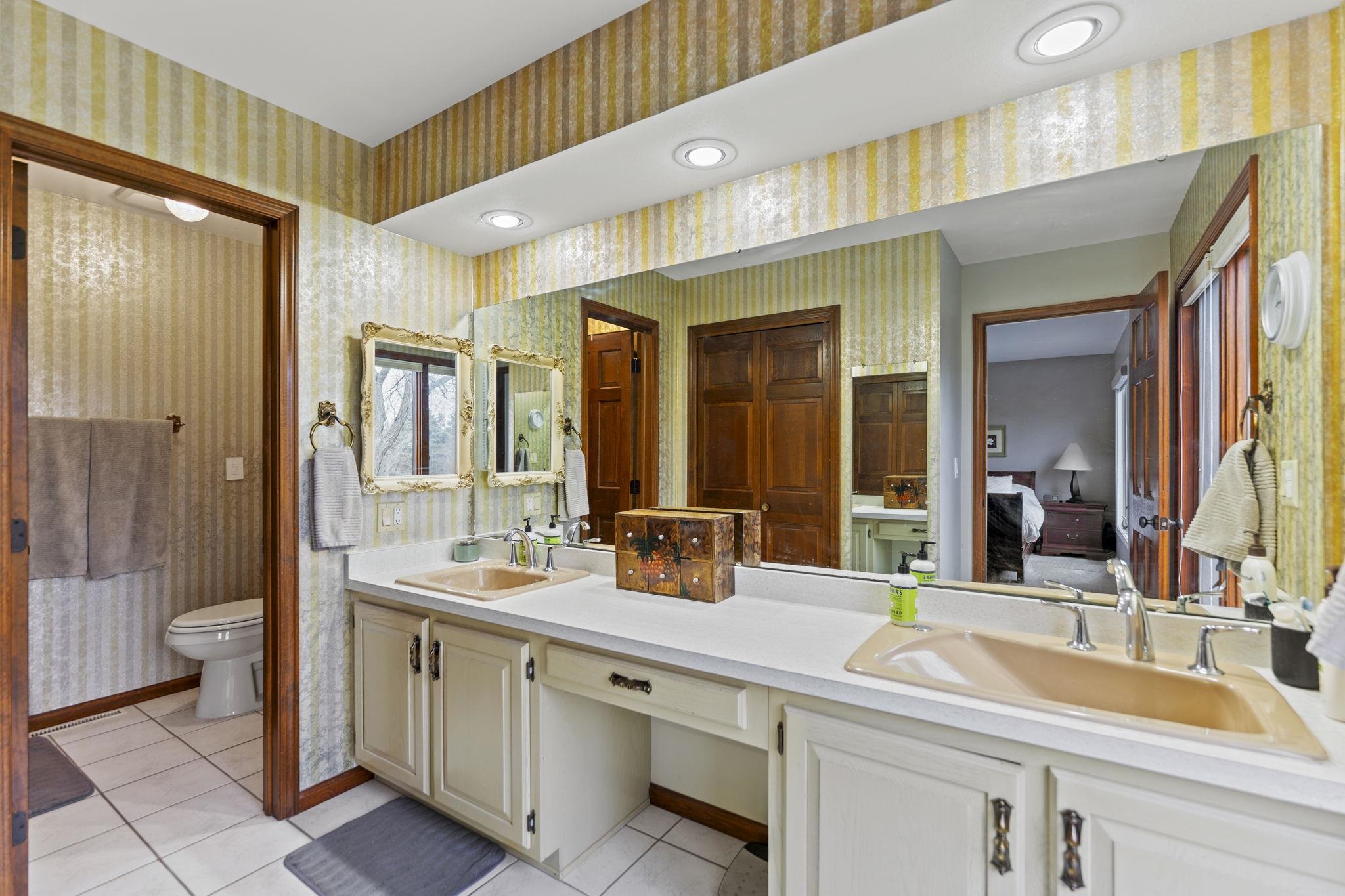 1628 Riverside Road Belvidere, IL 61008 - Photo 23 of 47 a bathroom with a double vanity sink and a mirror