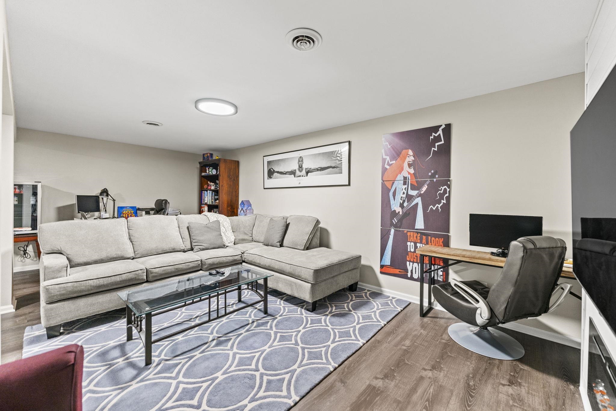 1628 Riverside Road Belvidere, IL 61008 - Photo 33 of 47 a living room with furniture and a flat screen tv