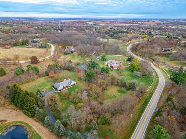 an aerial view of a house with a yard basket ball court and outdoor seating