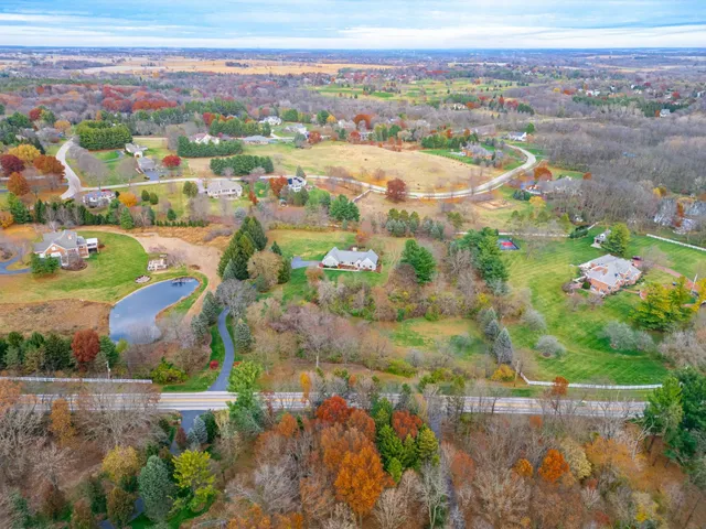an aerial view of residential houses with outdoor space and street view