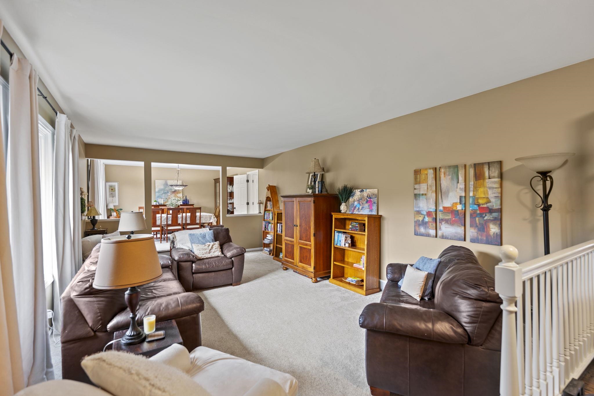1628 Riverside Road Belvidere, IL 61008 - Photo 7 of 47 a living room with furniture a large window and gym equipment