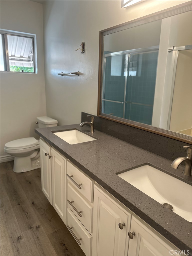 4533 Colbath Avenue, Unit 20 Sherman Oaks, CA 91423 - Photo 12 of 22 a bathroom with a granite countertop sink and a mirror