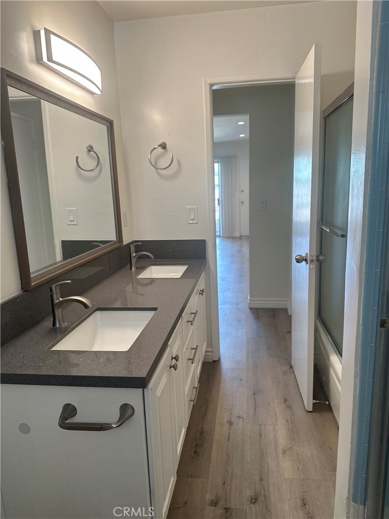 4533 Colbath Avenue, Unit 20 Sherman Oaks, CA 91423 - Photo 13 of 22 a bathroom with a sink double vanity granite and a mirror