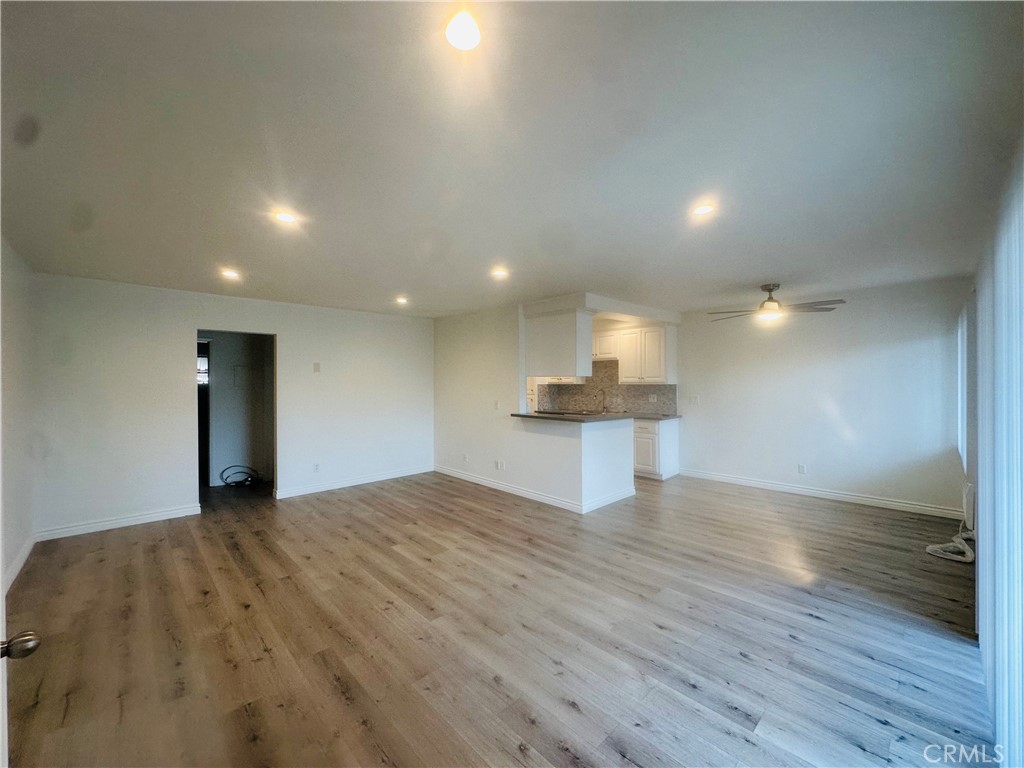 4533 Colbath Avenue, Unit 20 Sherman Oaks, CA 91423 - Photo 17 of 22 a view of a big room with wooden floor and a kitchen