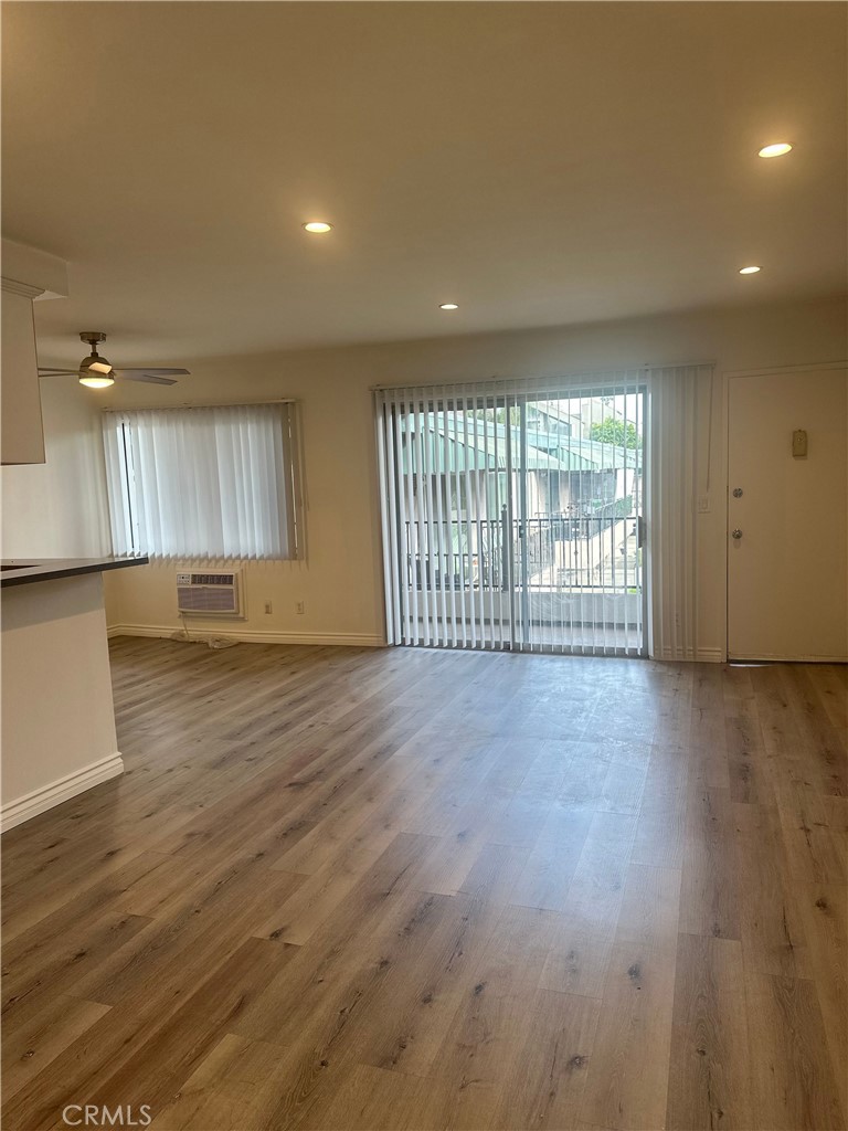 4533 Colbath Avenue, Unit 20 Sherman Oaks, CA 91423 - Photo 2 of 22 an empty room with wooden floor and windows