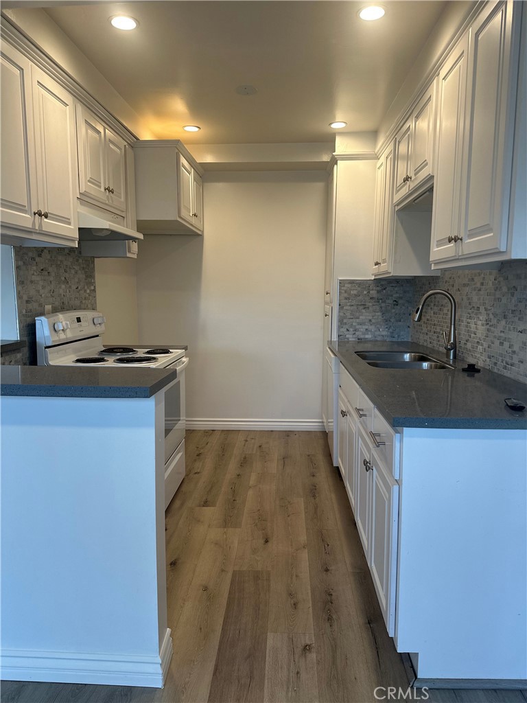 4533 Colbath Avenue, Unit 20 Sherman Oaks, CA 91423 - Photo 3 of 22 a kitchen with granite countertop a sink stove and cabinets