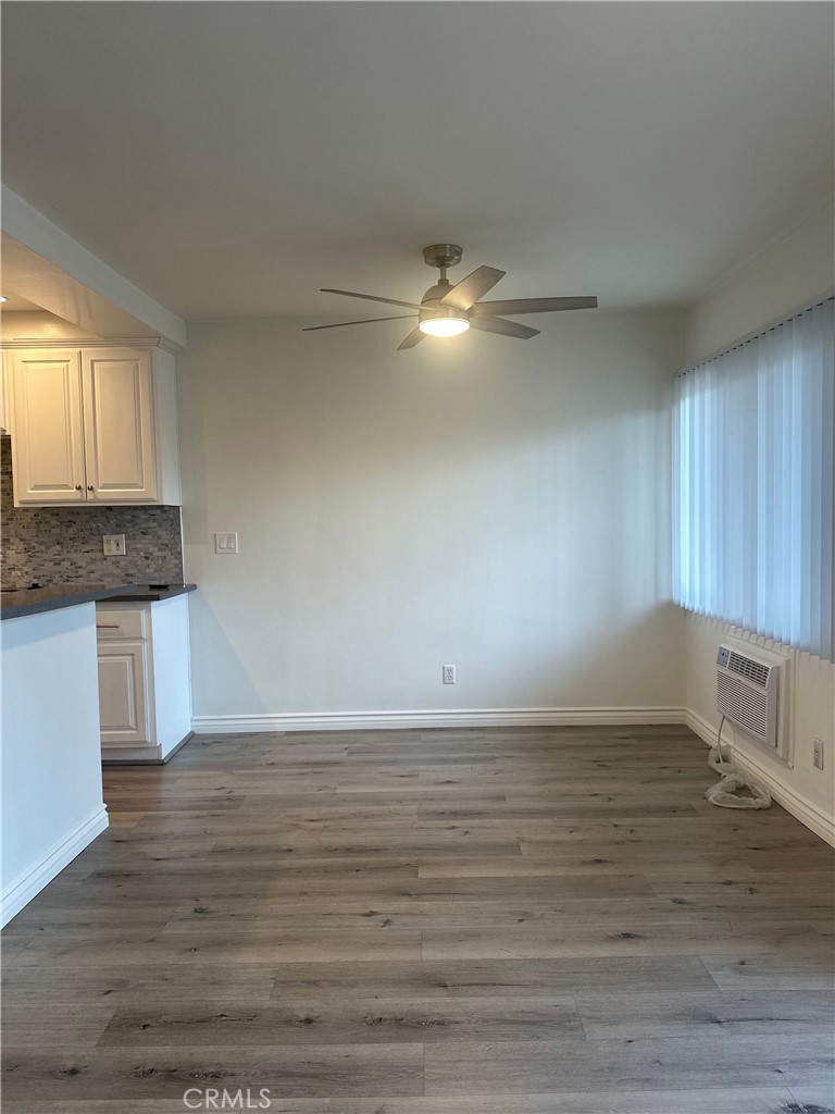 4533 Colbath Avenue, Unit 20 Sherman Oaks, CA 91423 - Photo 7 of 22 a view of kitchen and empty room with wooden floor