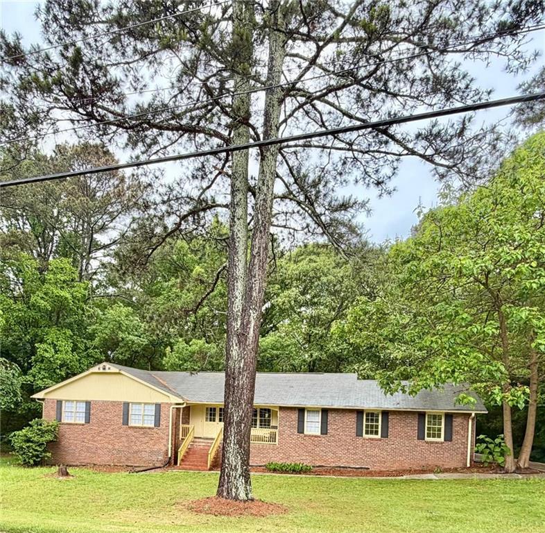 665 Arnold Road Lawrenceville, GA 30044 - Photo 2 of 48 a front view of a house with a yard and a tree
