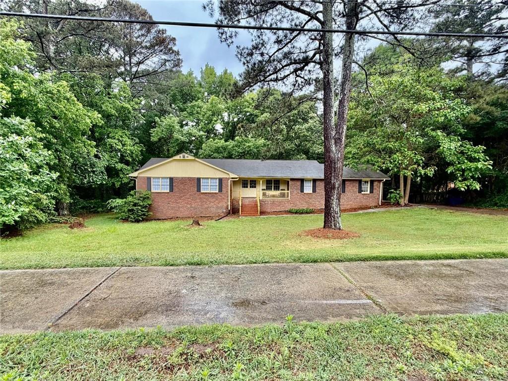 665 Arnold Road Lawrenceville, GA 30044 - Photo 48 of 48 a front view of a house with a yard and trees