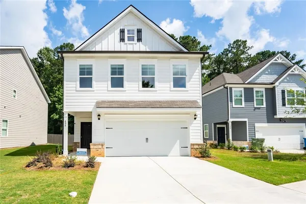 a front view of a house with a yard