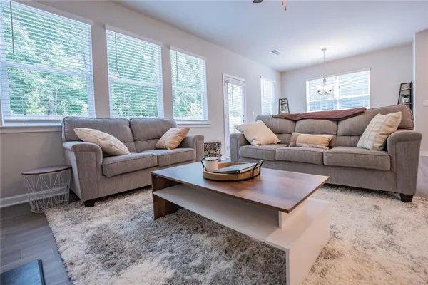 a living room with furniture and a large window