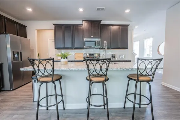 a view of a kitchen with dining table and chairs