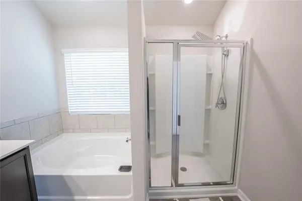a bathroom with a glass shower door