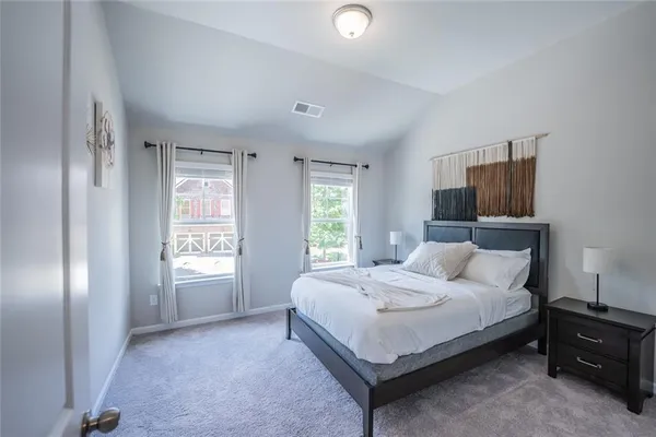 a bedroom with a bed lamp and window