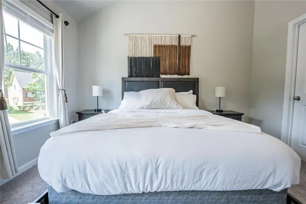 a bedroom with a bed and window